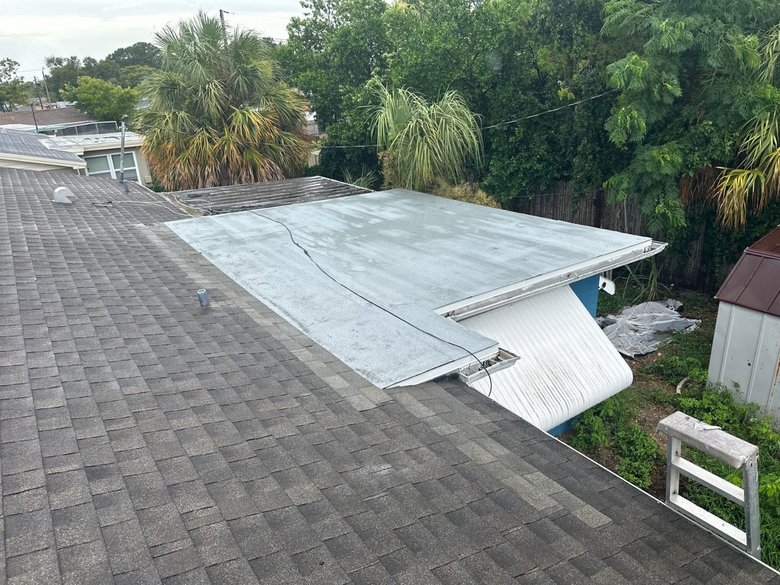 Finished low-slope roof tied into the shingle roof in Beacon Square, Holiday FL