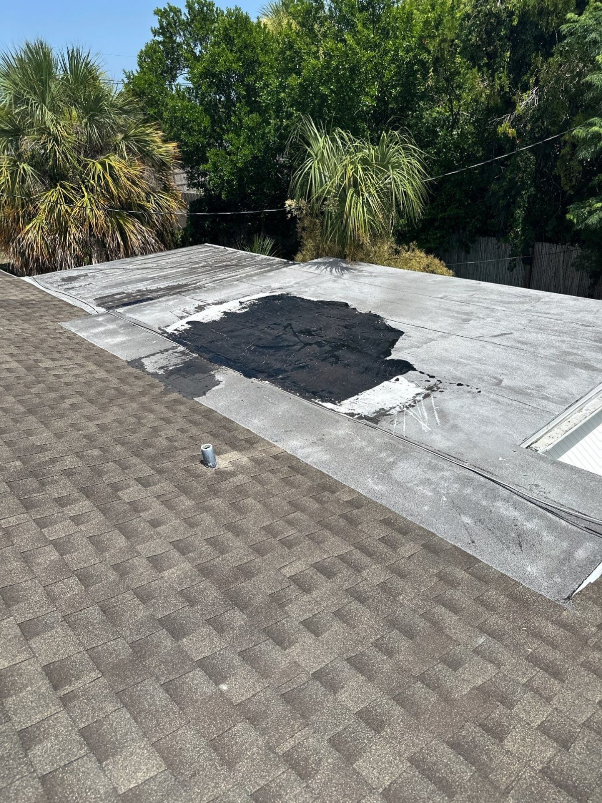 Patched low-slope roof section before repair in Beacon Square, Holiday FL