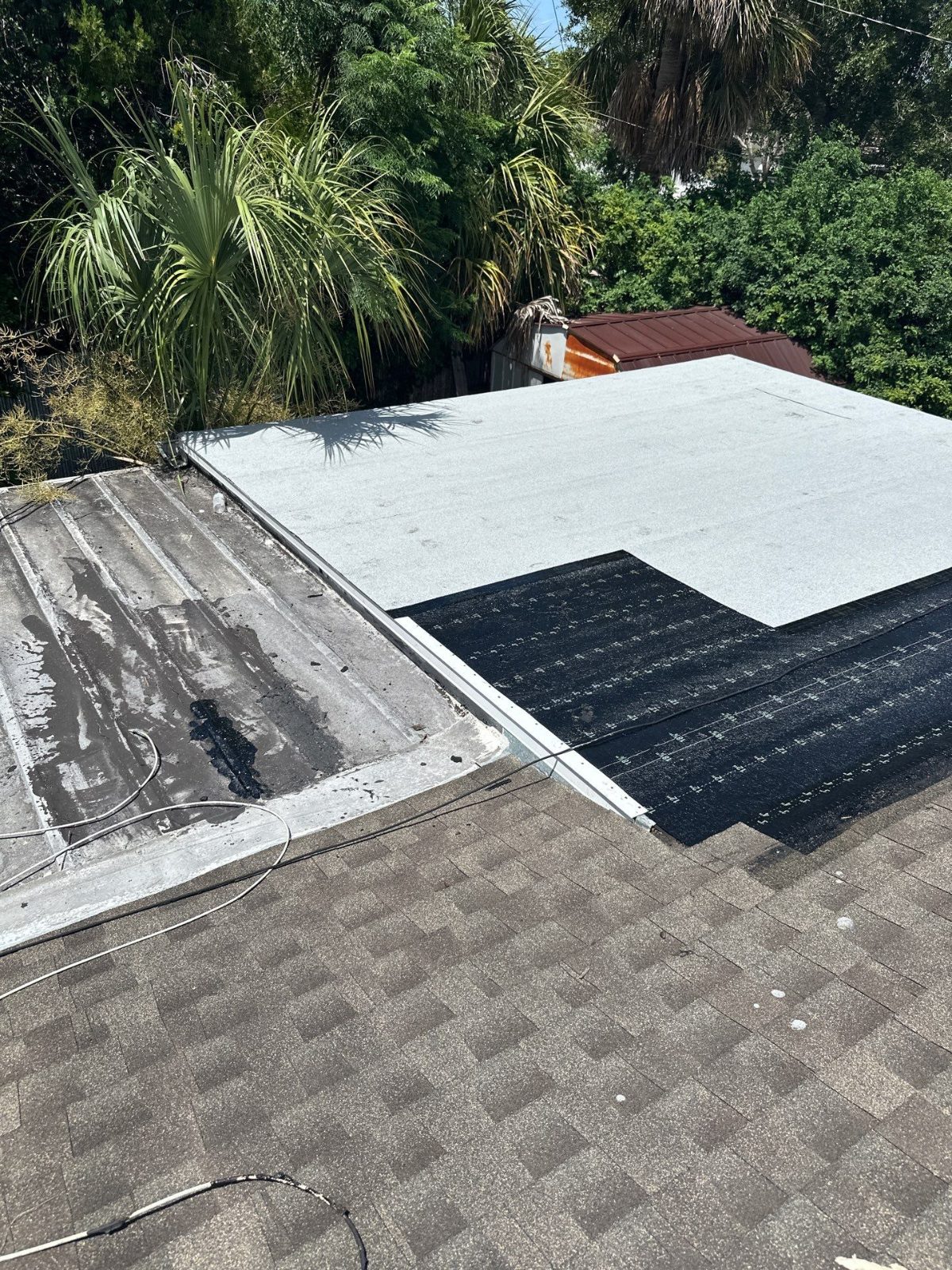 Old and new low-slope roofing side by side in Beacon Square, Holiday FL